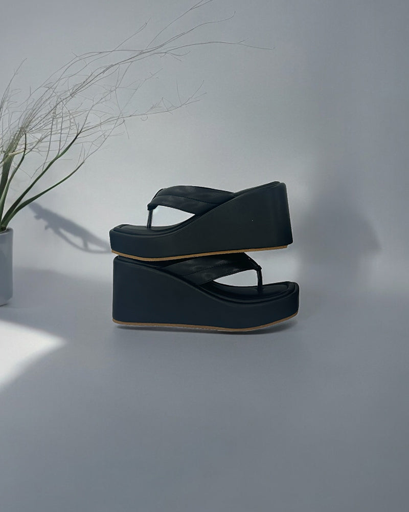 Black vegan leather wedge slides with open toe and 3-inch platform heel, ideal for casual and office wear
