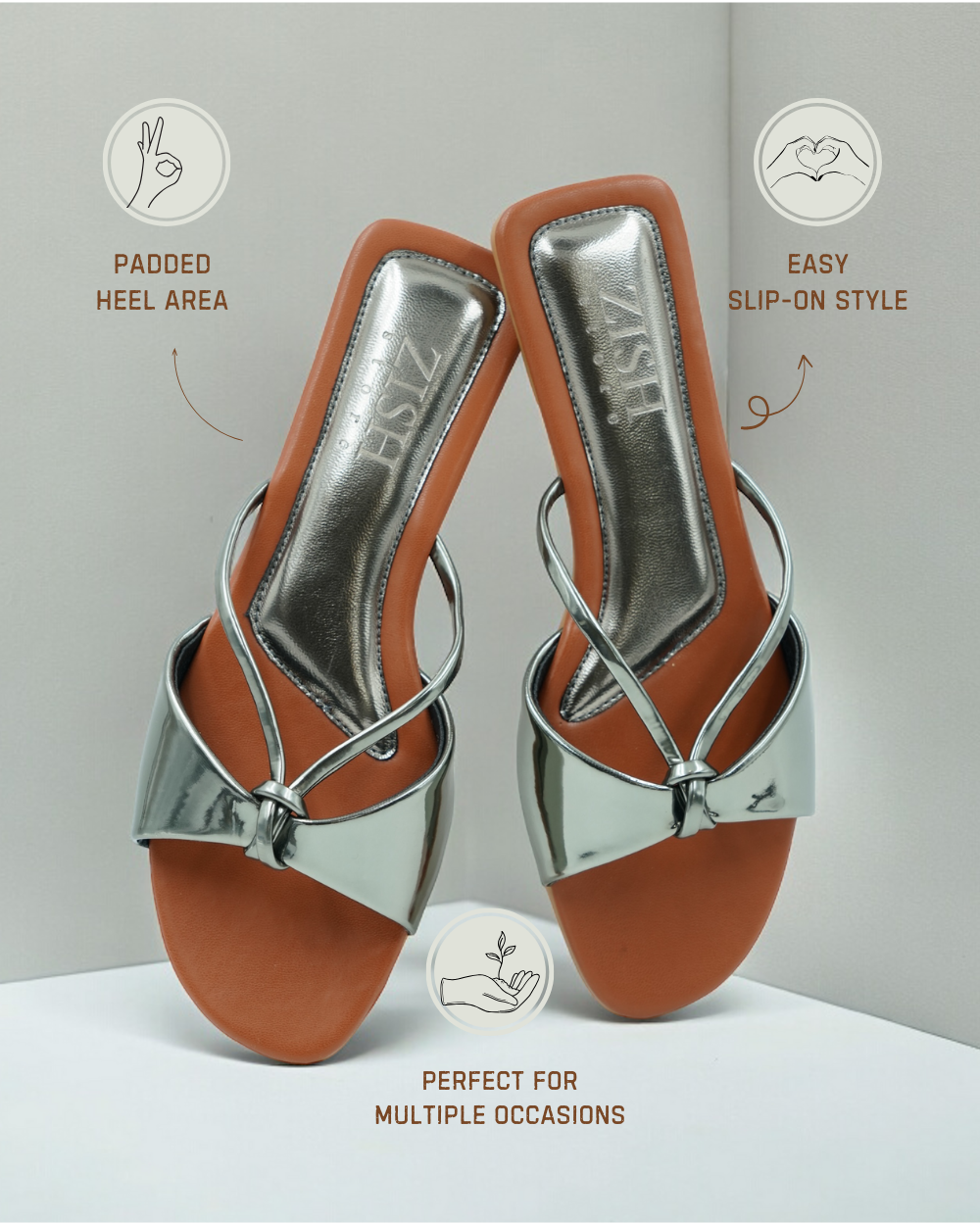 Silver Carolina Flats with glossy mirror strap and brown footbed, open-toe design, padded heel area, and easy slip-on style for casual and formal wear