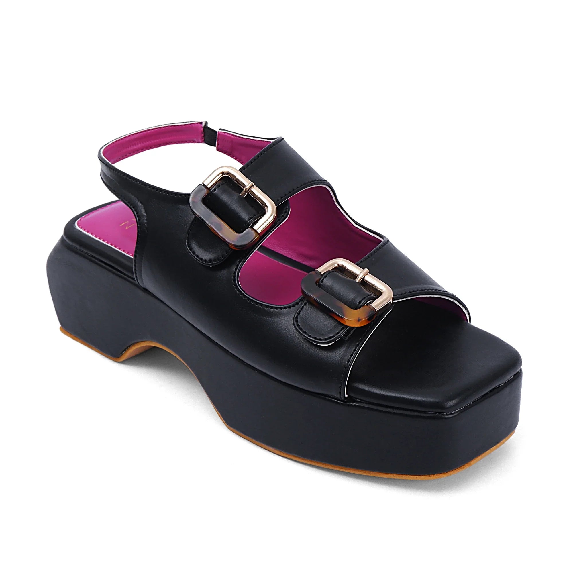 Black Lucy heels with open-toe design, dual buckle straps, and pink interior lining on a platform sole.