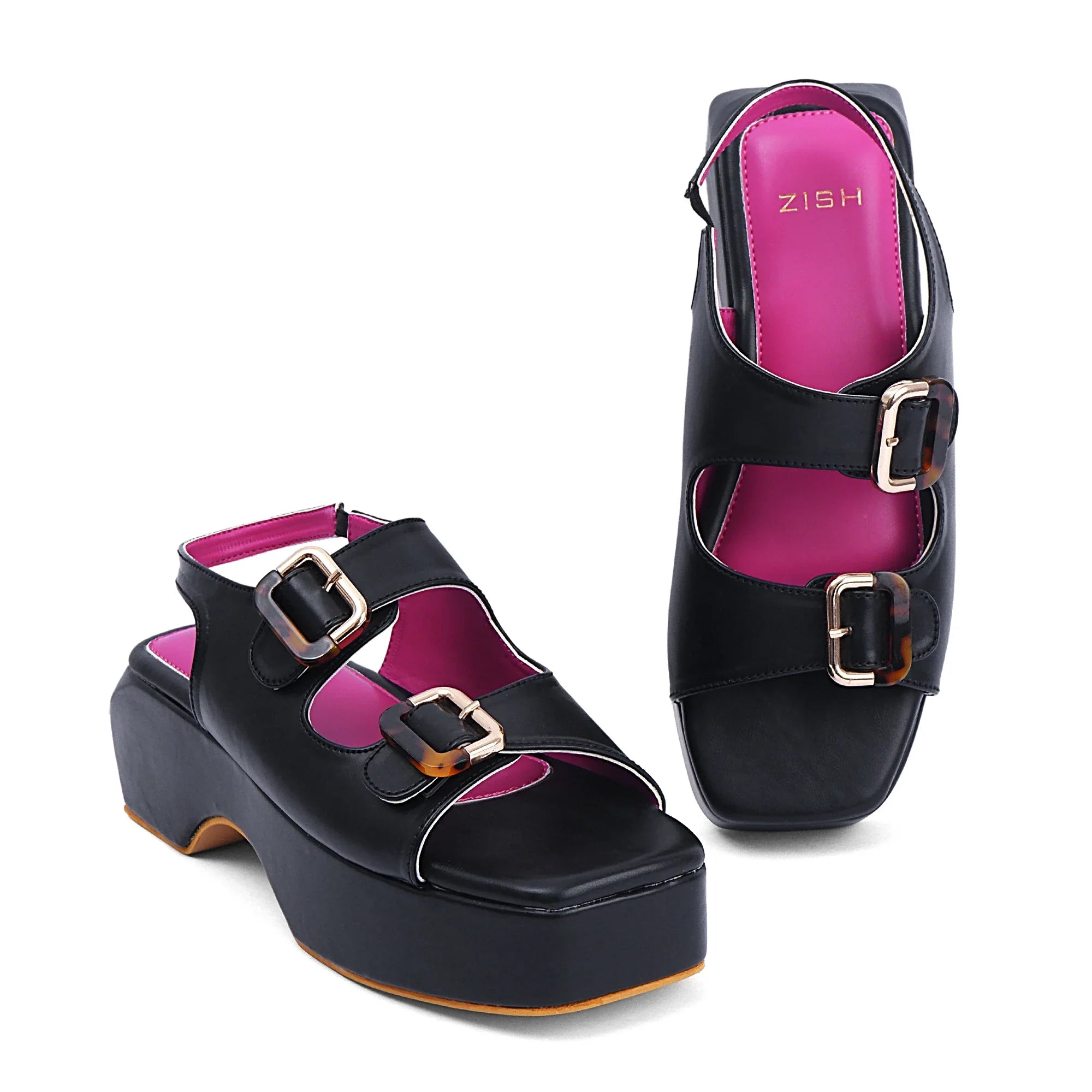 Black Lucy heels with open-toe design, double buckle straps, pink insole, and platform sole for casual wear