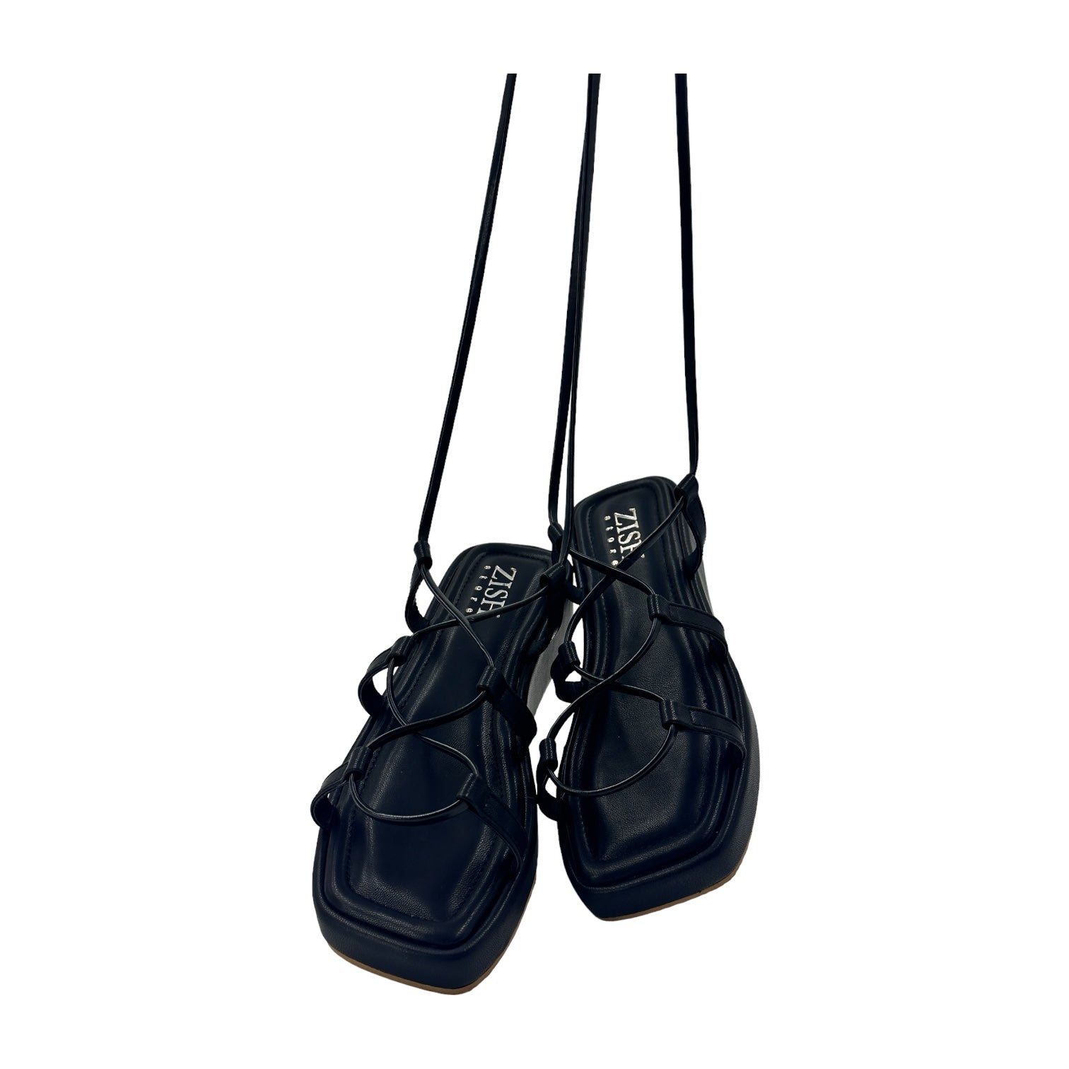 Black platform tie ups flats with open toes and slim long tie straps made of vegan leather