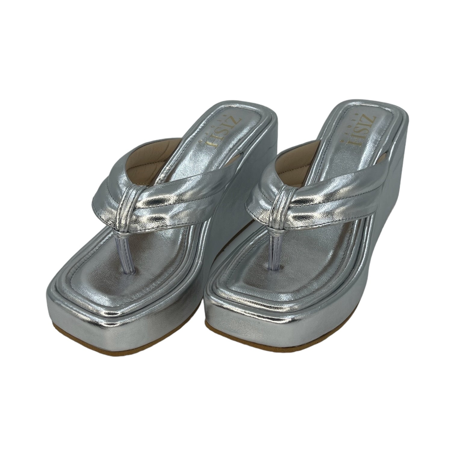 Pair of silver wedge slides with open toe and simple strap design, made of PU vegan leather with a 3-inch platform heel, ideal for semi-casual and office wear