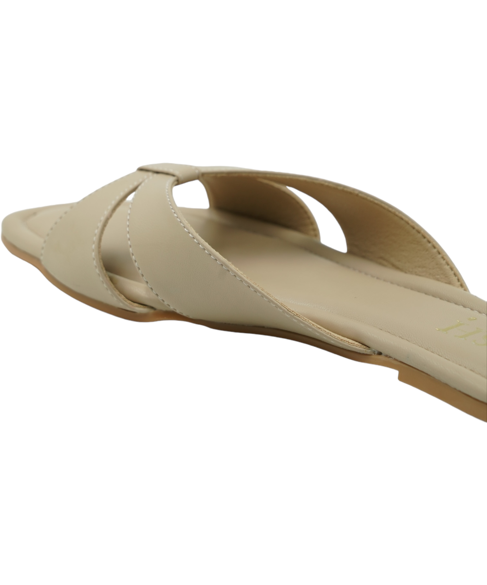 Beige Tokyo Flats with chic cross-strap design, flat sole, and cushioned vegan leather for comfort and style.