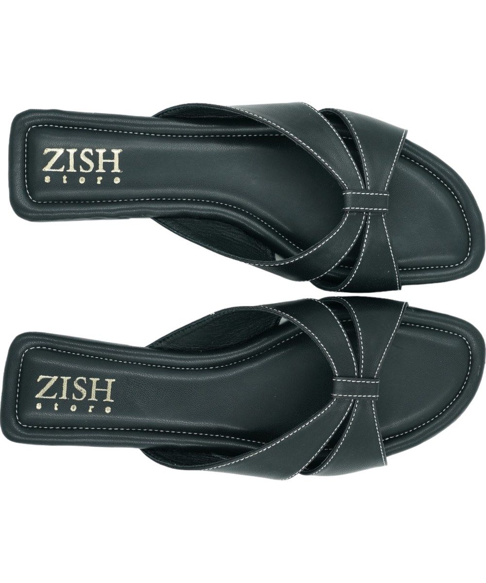 Black Tokyo Flats with cross-strap design, vegan leather, cushioned insole, and flat PVC sole for formal and casual wear.