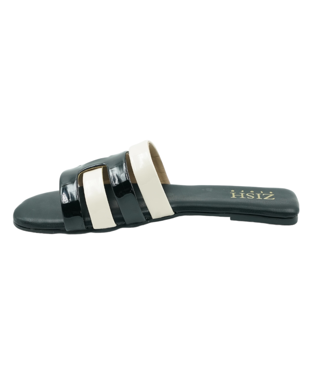 Black Azzura Flats vegan leather sandals with black and white geometric straps and flat PVC sole.