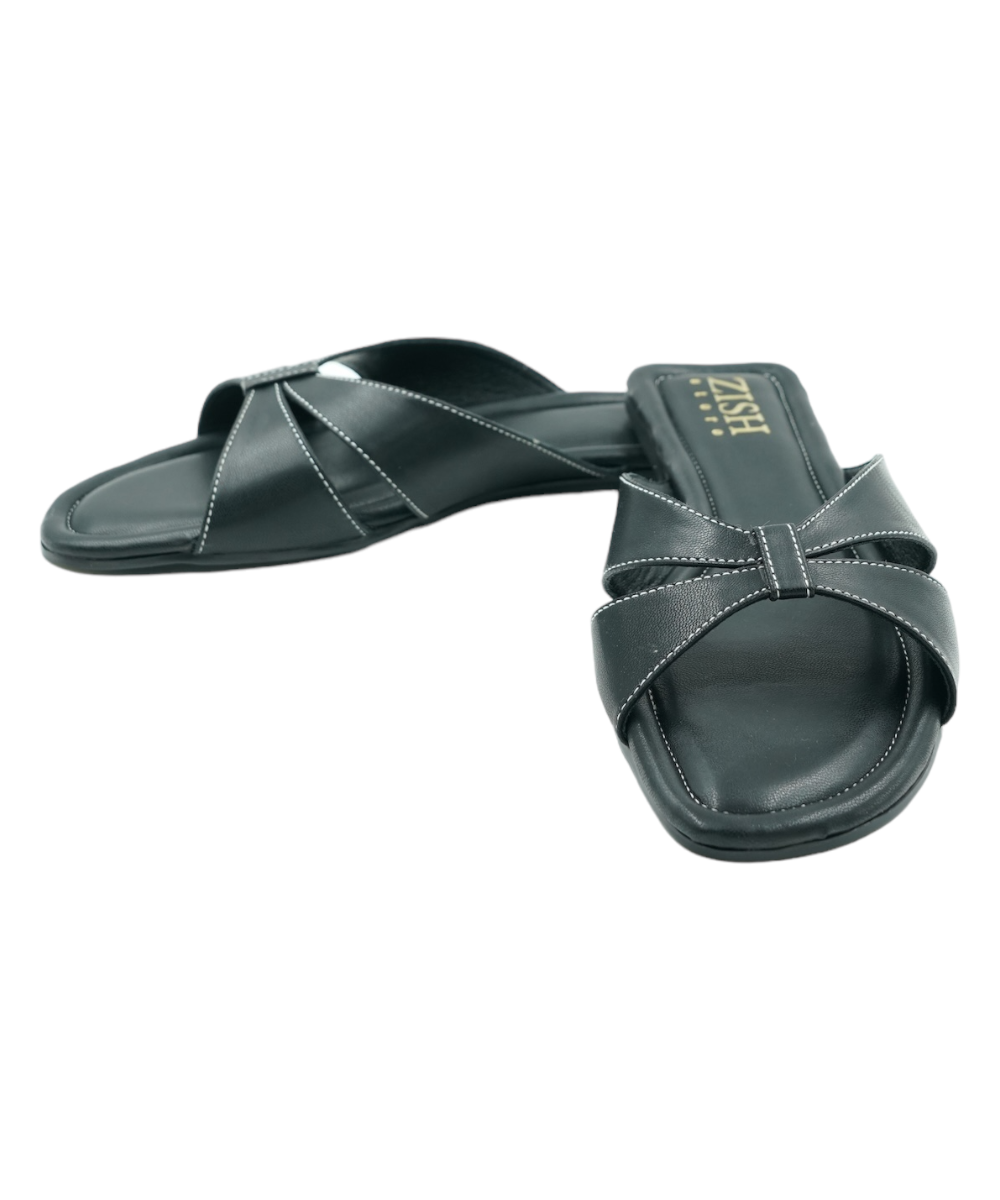 Black Tokyo Flats with cross-strap design, open toe, and cushioned vegan leather insole for comfort and style.