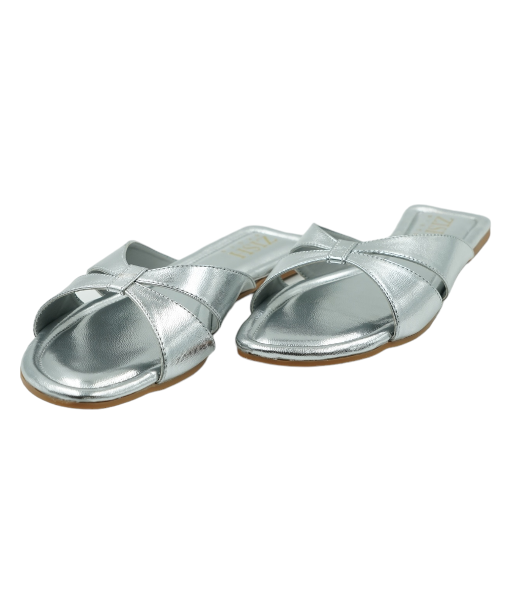 Silver Tokyo Flats with cross-strap design, open-toe vegan leather sandals, flat heel, and cushioned insoles for comfort.