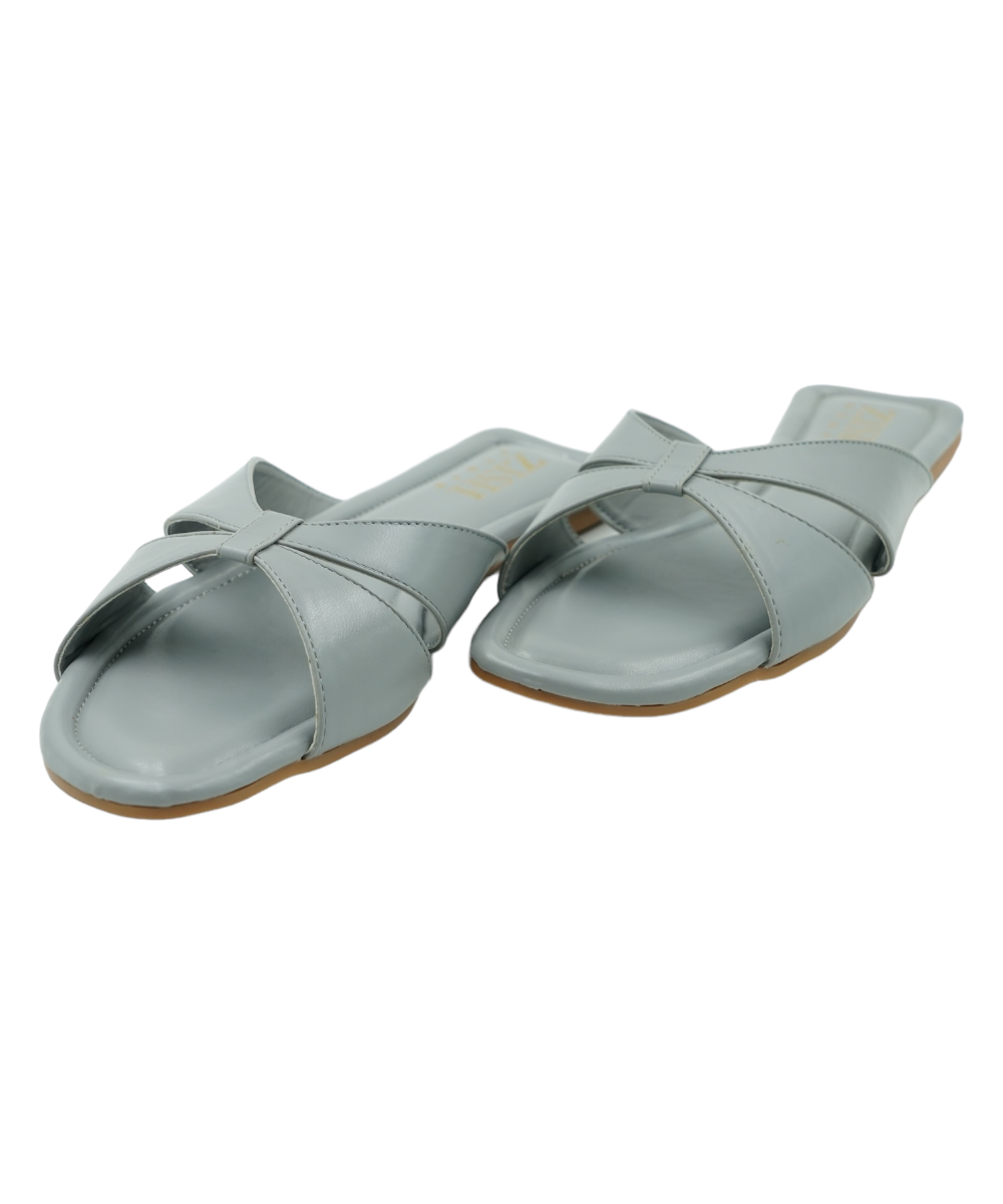 Grey vegan leather cross-strap flats with open toe and PVC sole, perfect for casual and formal wear