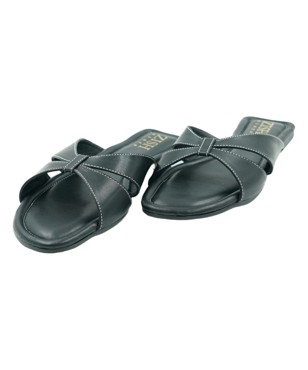 Black Tokyo Flats with cross-strap design, vegan leather, cushioned insole, and flat PVC sole for casual and formal wear.