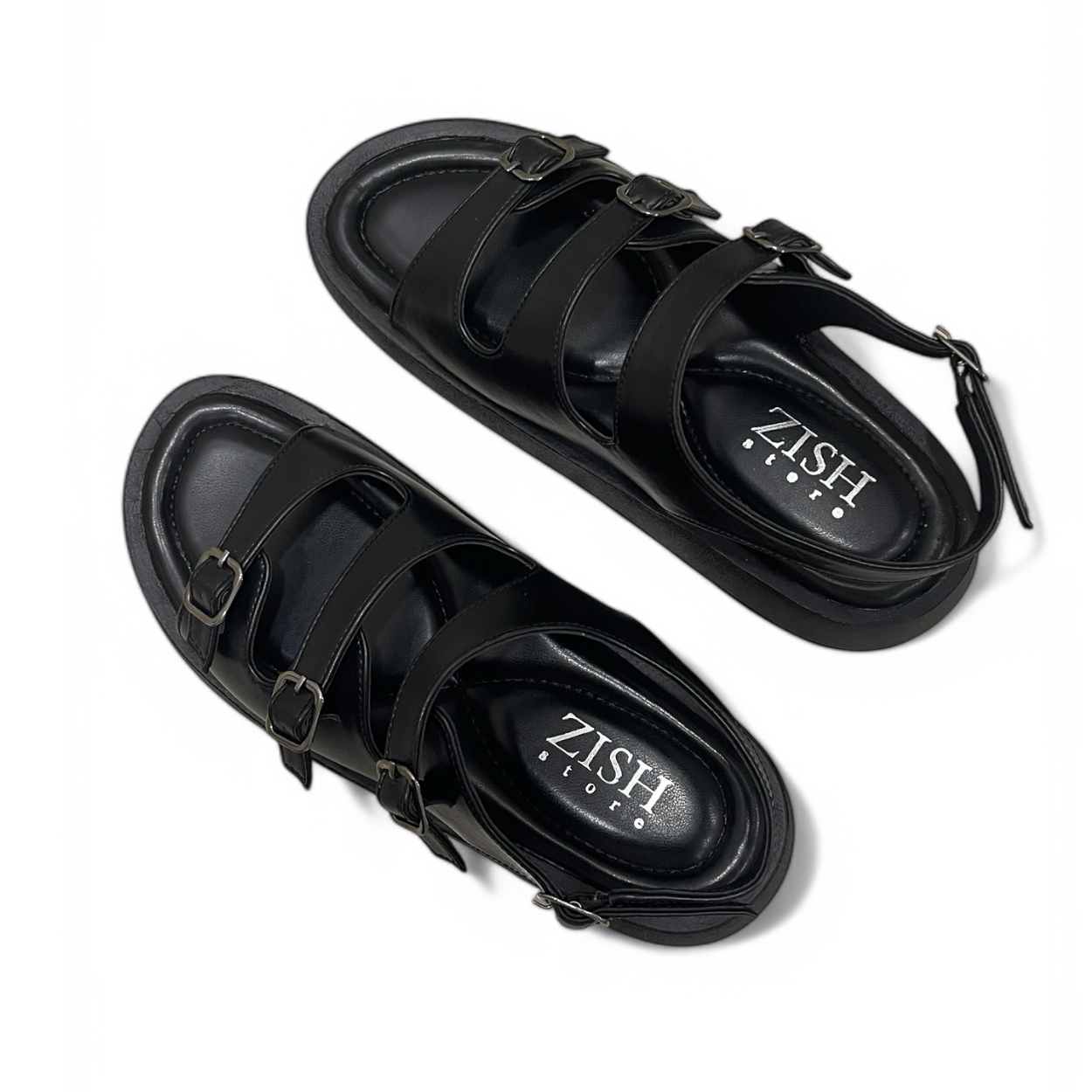 Black triple buckle sandals with adjustable straps and cushioned footbed, made of vegan leather, ideal for casual and semi-casual wear.