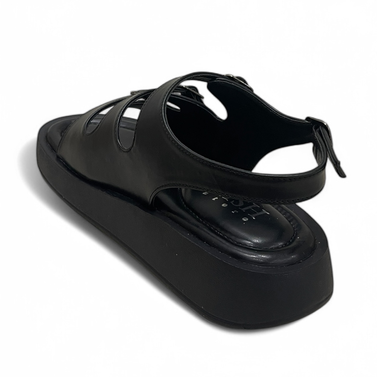 Black triple buckle sandals with adjustable straps and cushioned footbed, made of vegan leather with a 1-inch heel.