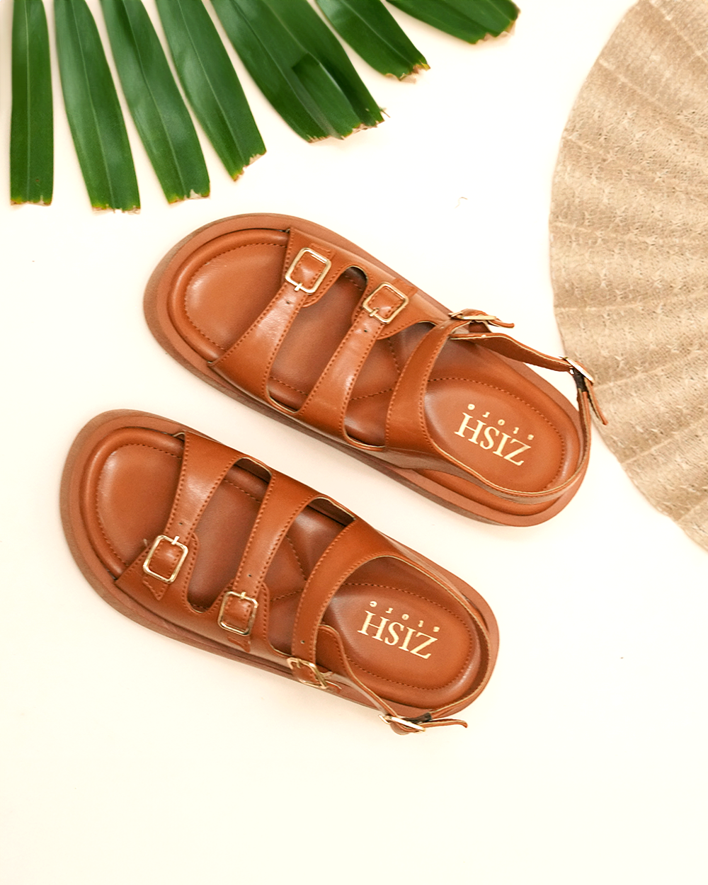 Tan triple buckle sandals with cushioned footbed and adjustable straps, made of vegan leather, perfect for casual wear