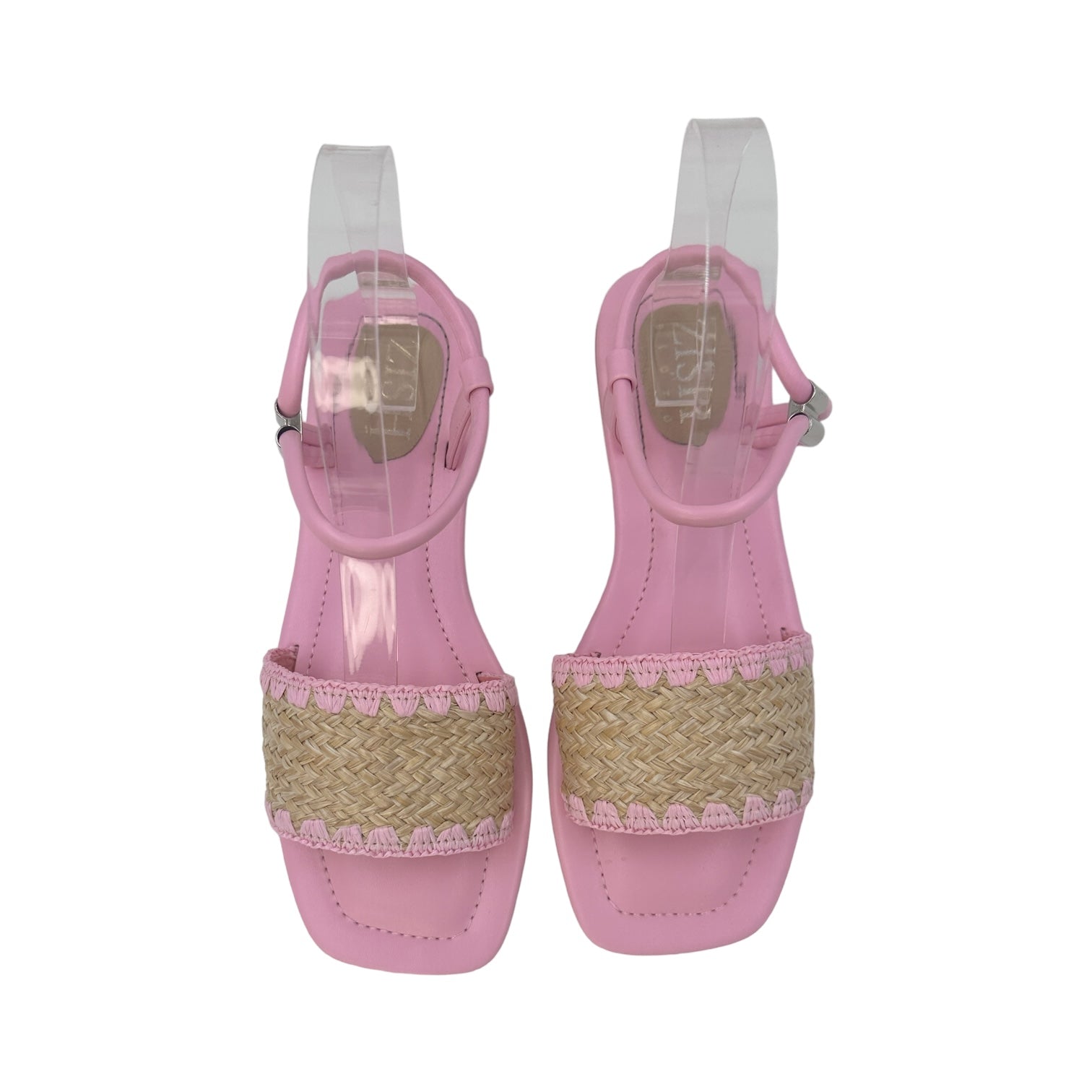 Top view of pink flat sandals with cane woven upper and ankle strap closures
