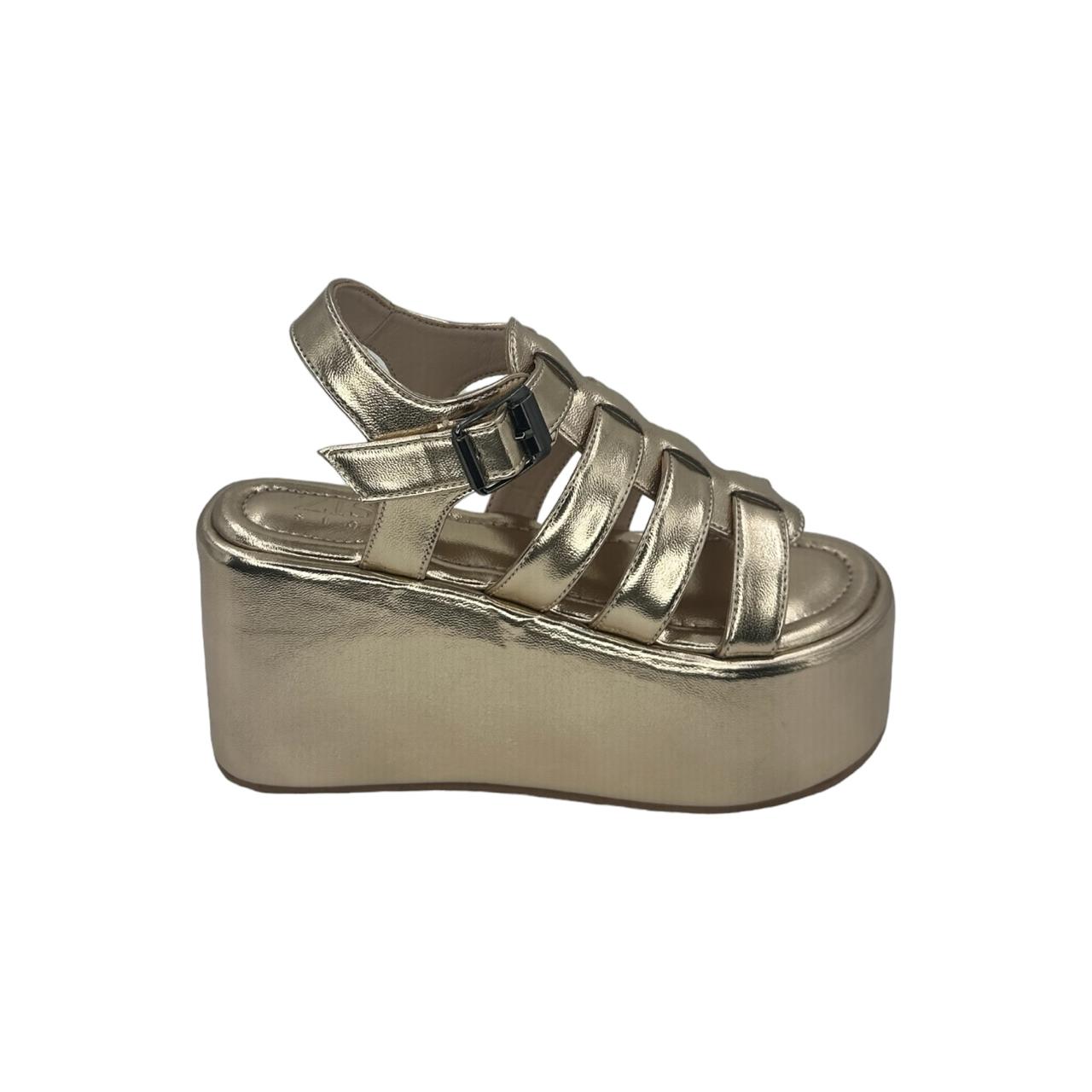 Gold chunky heel caged platform sandals with open toe and adjustable buckle strap.