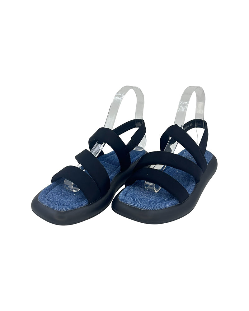 Black beach-inspired sandals with elastic straps, flat PU sole, and blue footbed for comfortable summer wear.